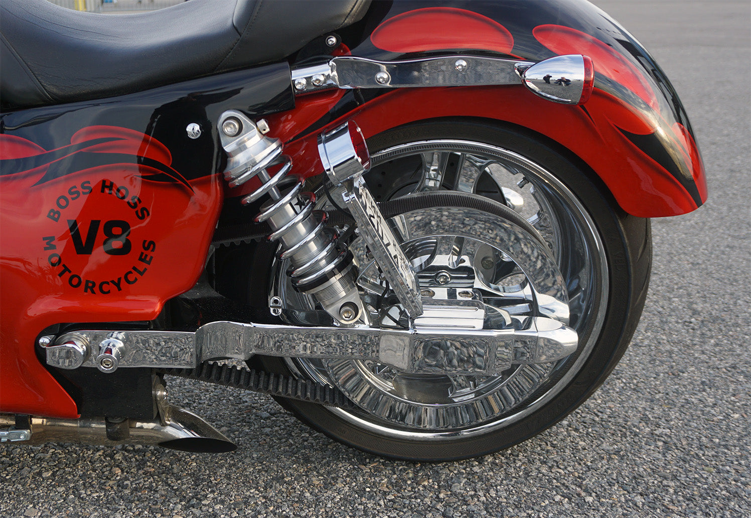 Close-up of the Boss Hoss Cruiser Bike's rear suspension, belt drive, and V8 badging